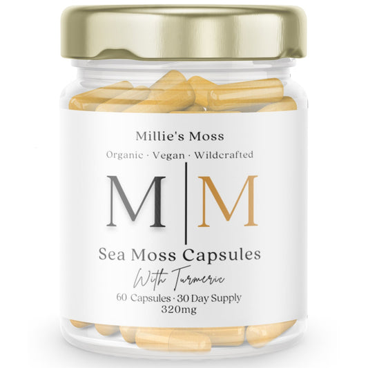 A clear glass jar with a gold lid containing capsules labeled 'Sea Moss Capsules with Turmeric, indicating the product is a dietary supplement.