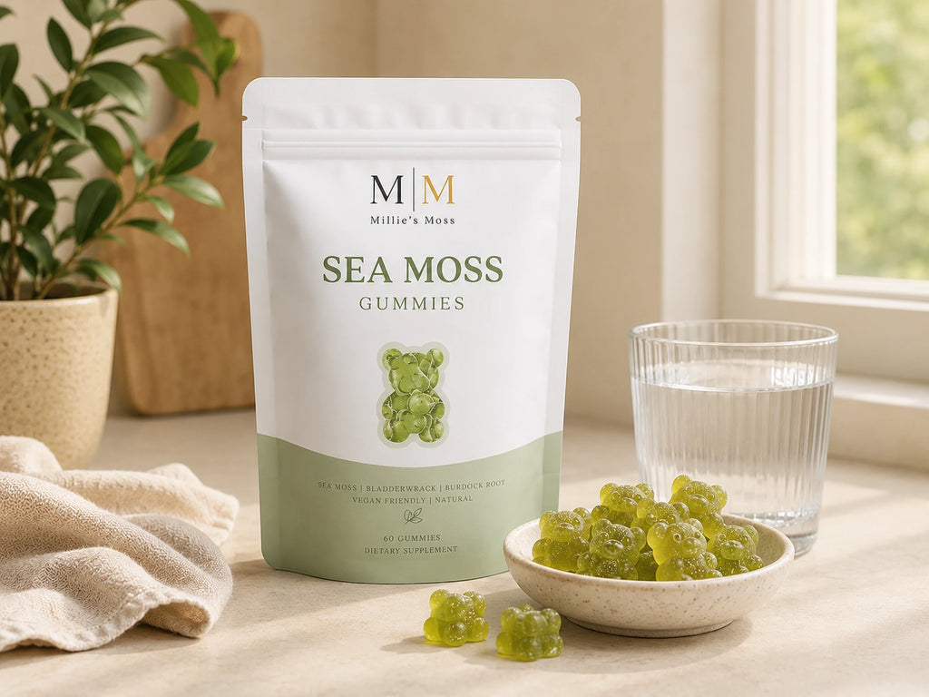 Millie’s Moss Apple Sea Moss Gummies pouch with green gummies and a glass of water on a kitchen counter.