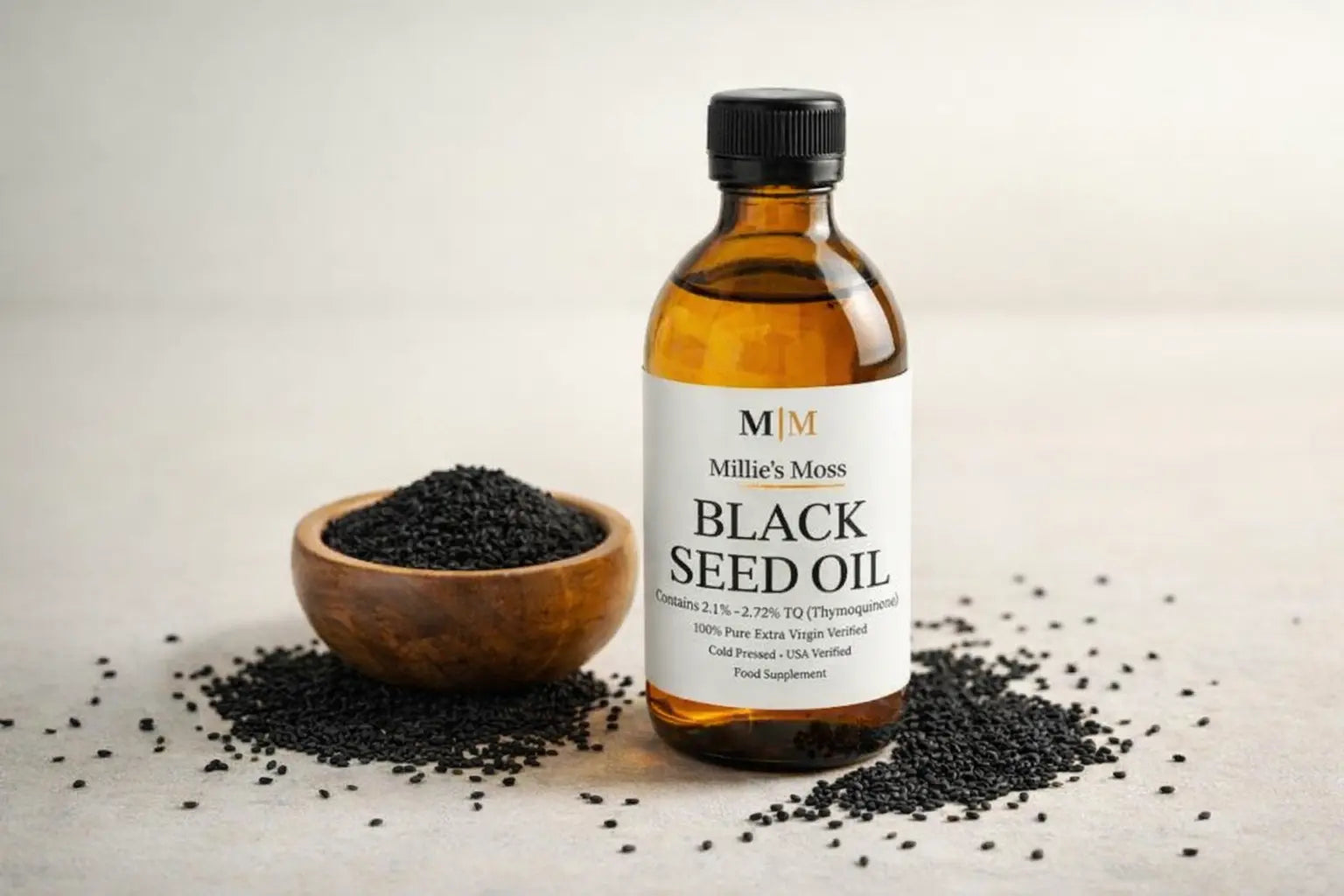 Bottle of black seed oil with Nigella sativa seeds showing the natural source of the oil.