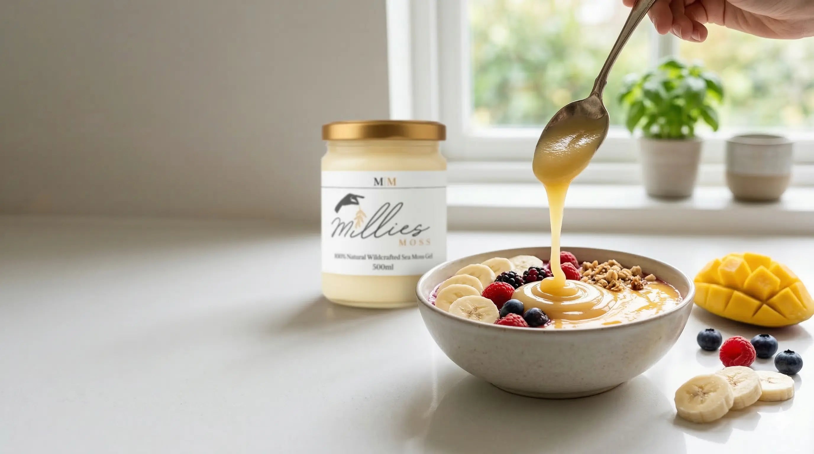 Adding sea moss gel to a healthy breakfast bowl with fruit and granola