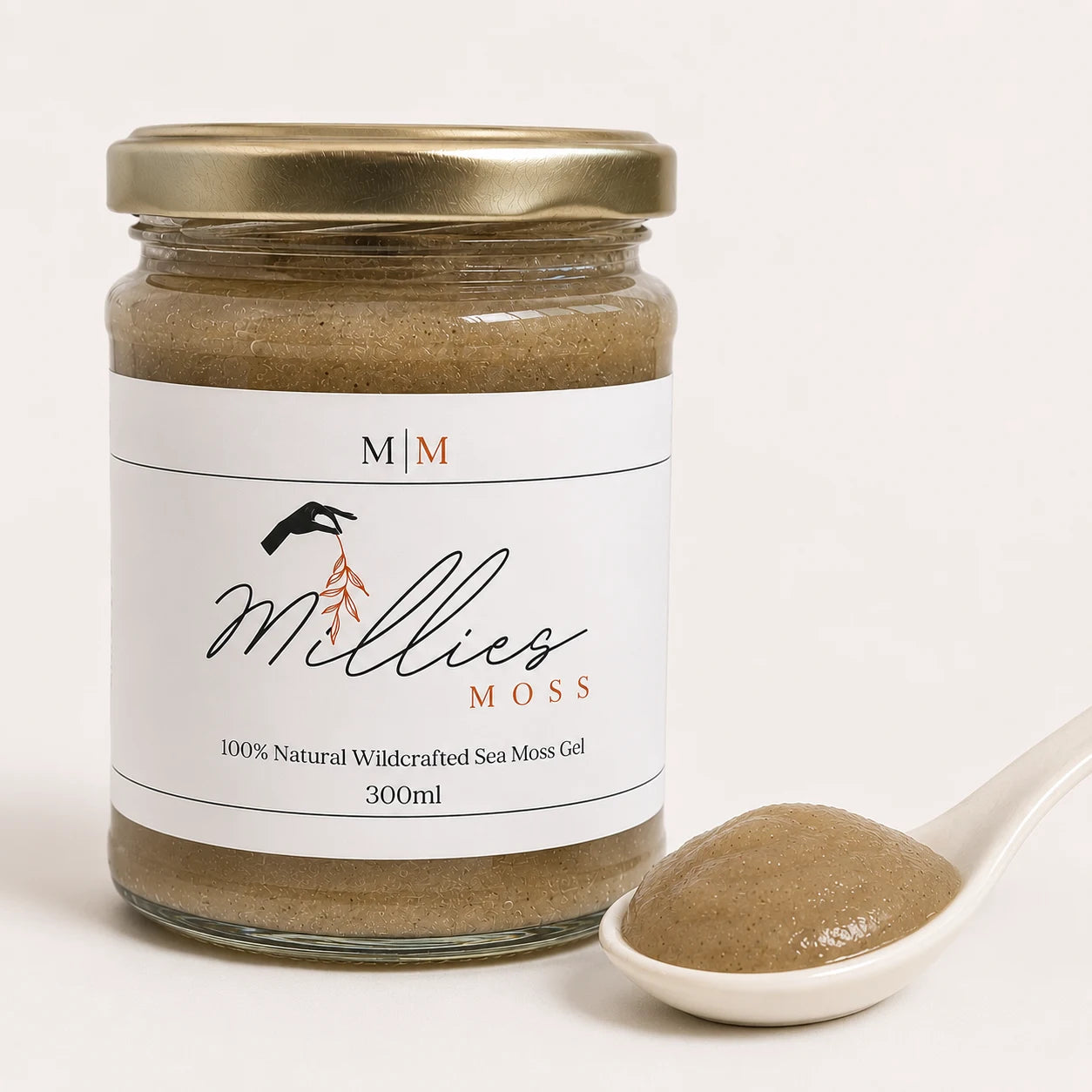 Close-up of Millie's Moss Bladderwrack & Burdock Root Infused Sea Moss Gel showing its naturally blended texture beside the jar