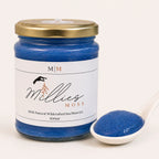 Close-up of Millie's Moss Blue Spirulina Infused Sea Moss Gel showing its naturally blended texture beside the jar