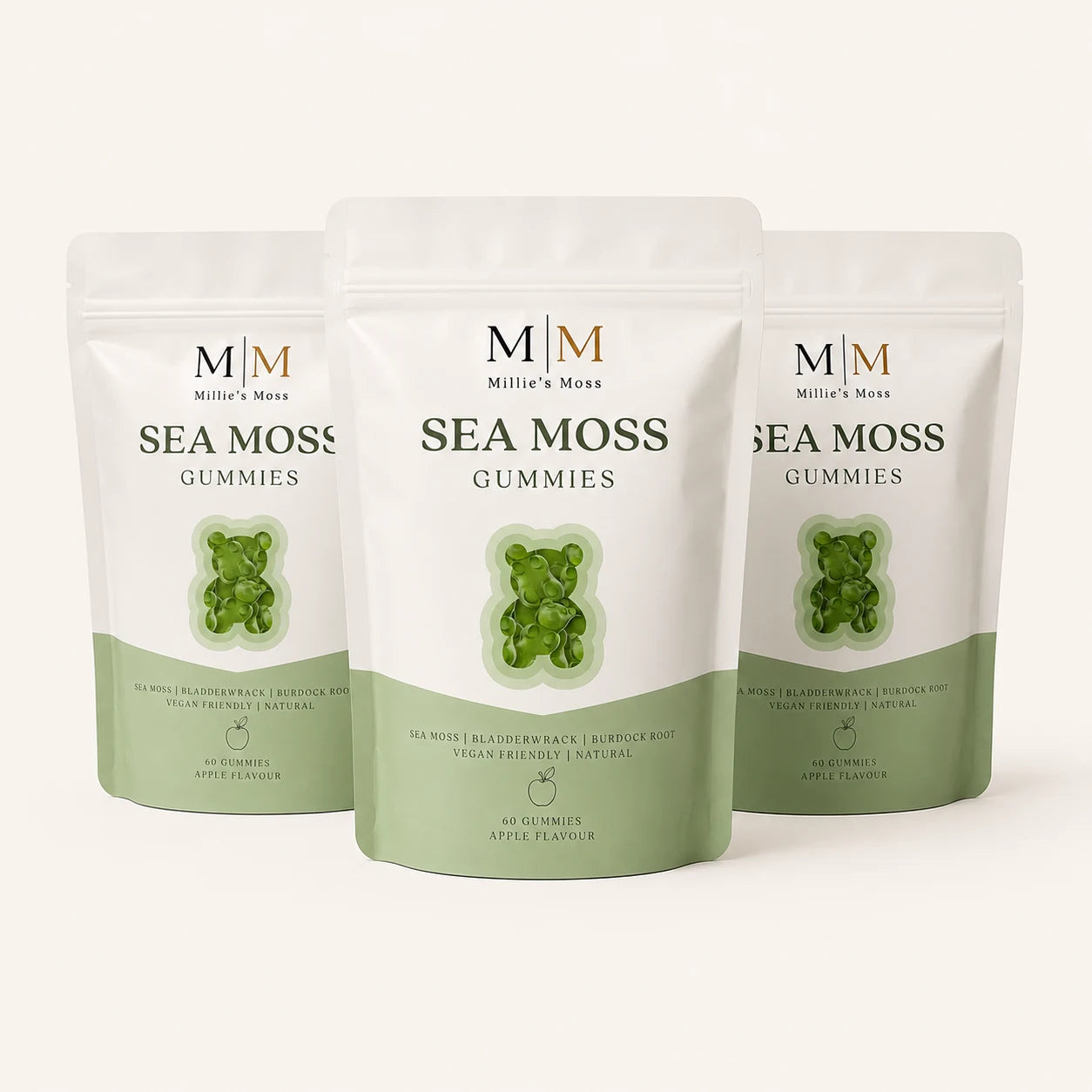 Three Millie’s Moss Apple Sea Moss Gummies pouches on a soft cream background.