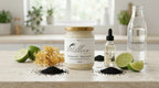 Sea moss gel jar with black seed oil lime raw sea moss and spring water arranged on a kitchen counter