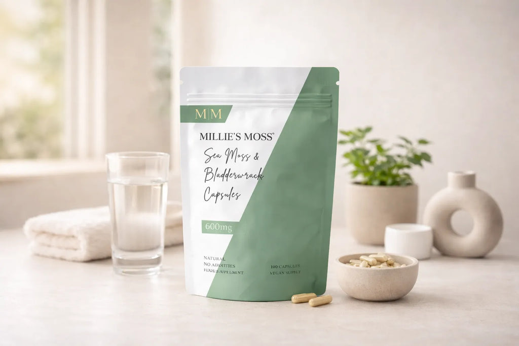 Millie’s Moss sea moss and bladderwrack capsules displayed with a glass of water in a clean wellness setting.