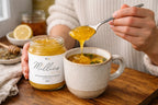 Spoonful of sea moss gel with Manuka honey being added to a warm herbal tea