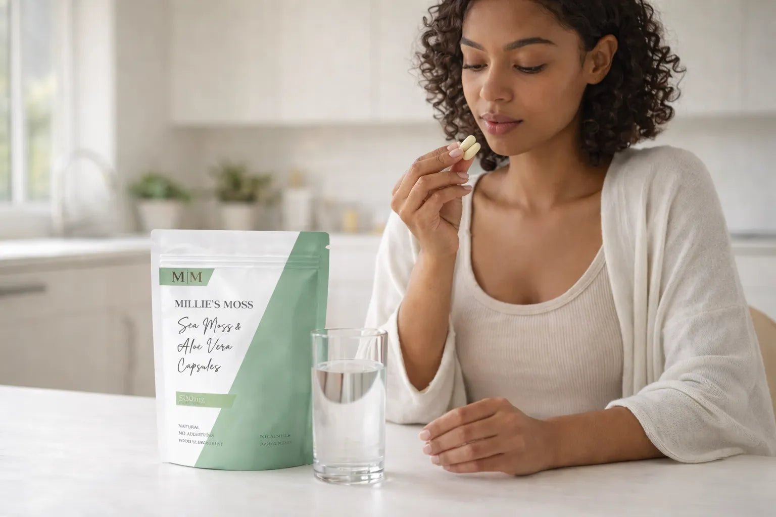 Woman taking sea moss and aloe vera capsules with water as part of a healthy daily supplement routine.