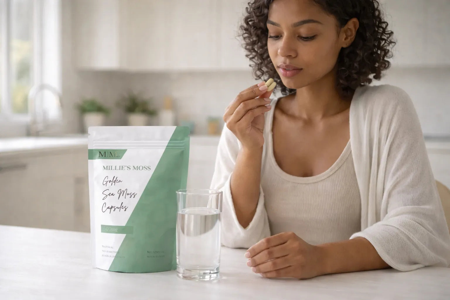 Woman taking sea moss capsules with water as part of a healthy daily supplement routine.
